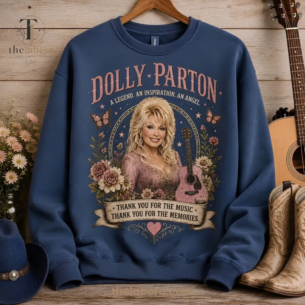 Dolly Parton Legend Inspiration Angel Sweatshirt Thank You For The Music 9 Cream sweatshirt featuring Dolly Parton portrait in circular frame with acoustic guitar, butterflies, rose florals, and thank you message banner